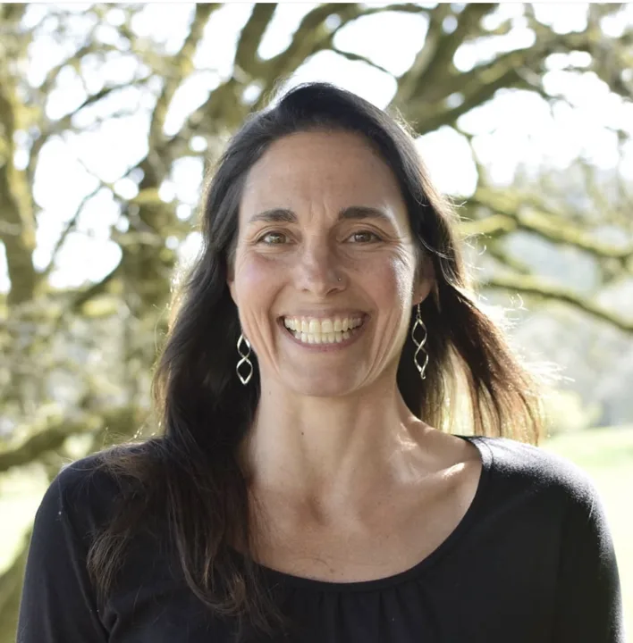 Amy Halloran-Steiner smiling under an oak tree